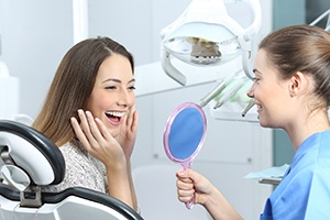 Woman admiring her smile after direct dental bonding