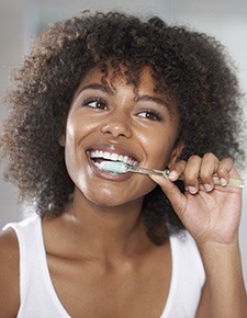 Young woman brushing her teeth