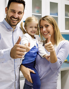 Happy family posing in dental office