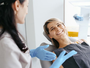 Dentist and patient having friendly conversation