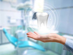 Dentist holding a computer model of a tooth