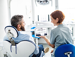 Friendswood dentist talking to patient during dental implant consultation