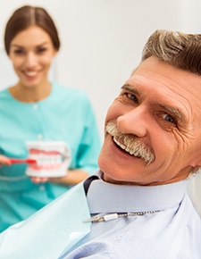 An elderly man getting dentures 