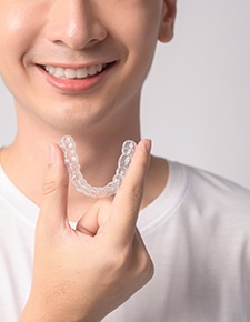 Close-up of man holding Invisalign in Friendswood, TX