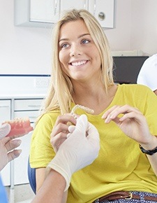 Woman in dental chair with Invisalign aligner