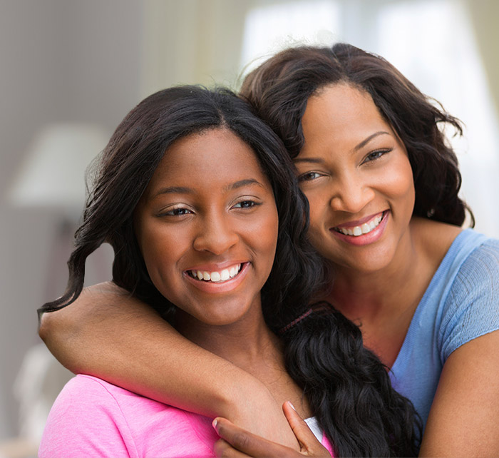 Two young women smiling after orthodontic treatment