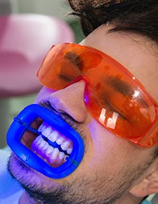 Man receiving in-office teeth whitening