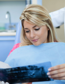 Woman looking at x-rays after tooth extractions