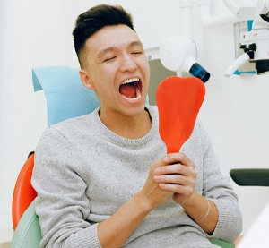 Man looking in dental mirror