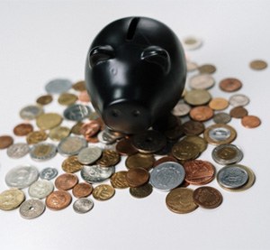 Black piggy bank on coins