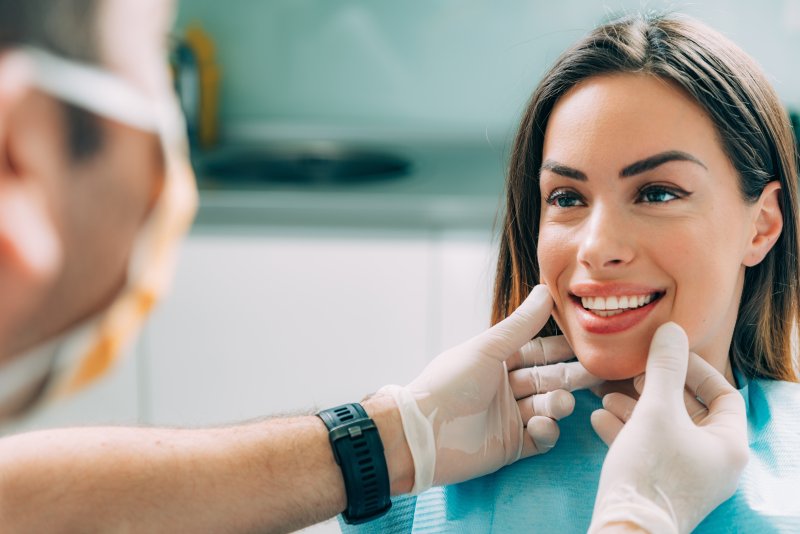 A cosmetic dentist treating a patient