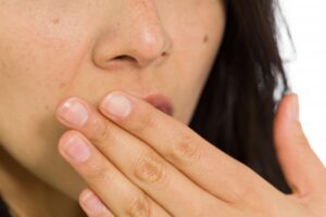 Woman with a metallic taste in her mouth
