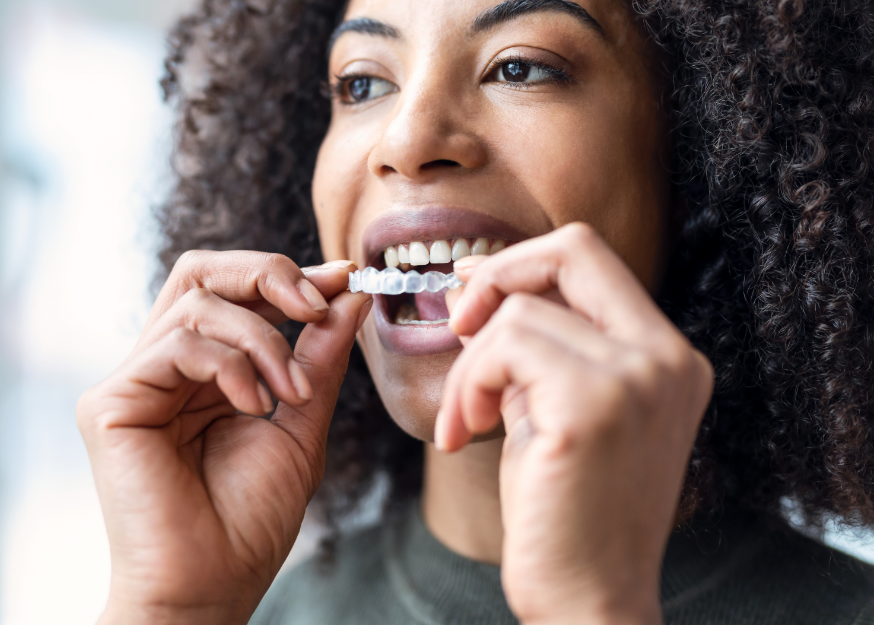 Woman putting in Invisalign
